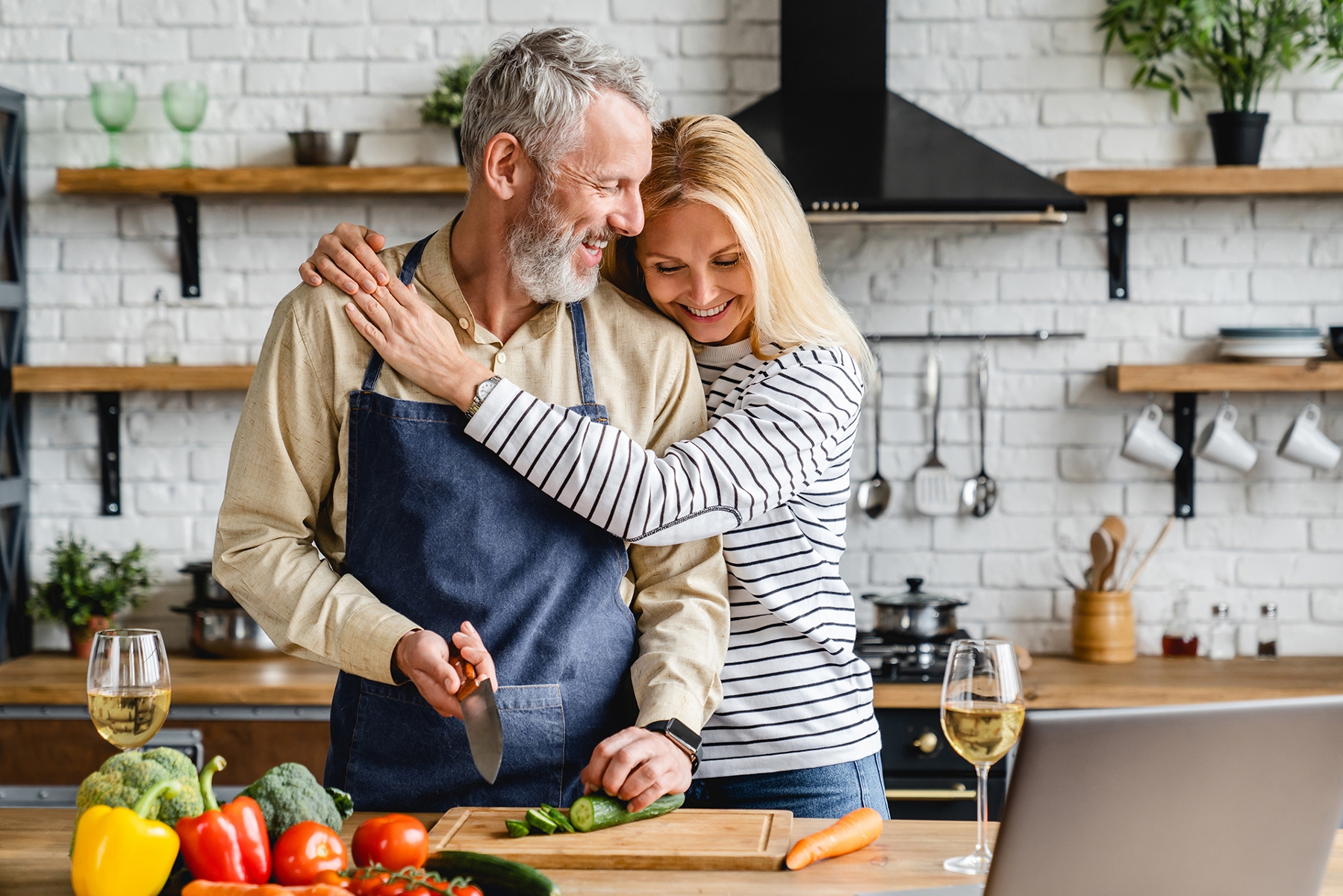 couple laughing in kitchen | Dental Crowns Charlestown