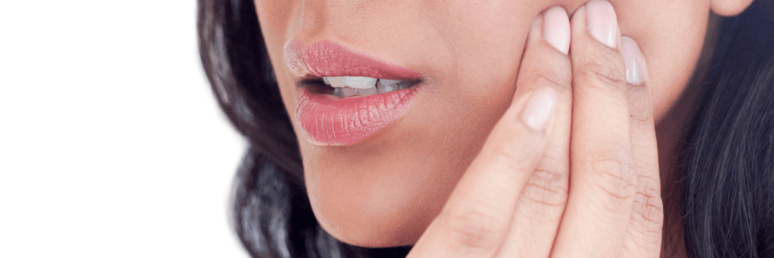 woman holding her left cheek