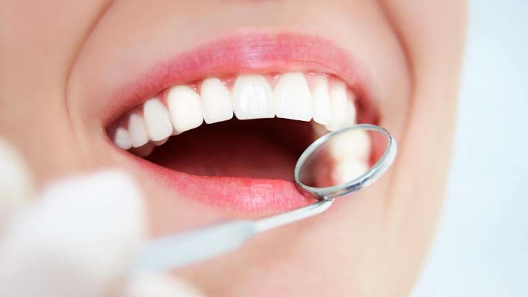 A woman getting her teeth cleaned | dentist in Charlestown