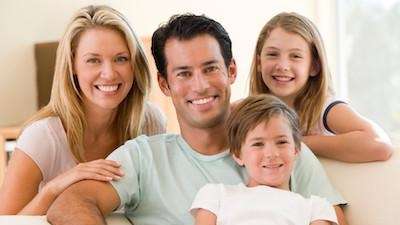 A smiling family posing for a picture | dental exam Charlestown NSW